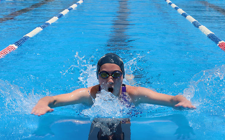 Student in pool at school swimming carnival