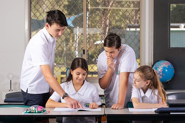 Year 8 students in class working on a team project