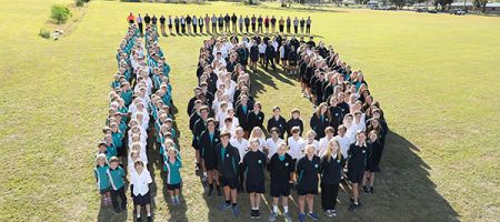 Students and staff forming the number 10 celebrating the schools 10 year anniversary