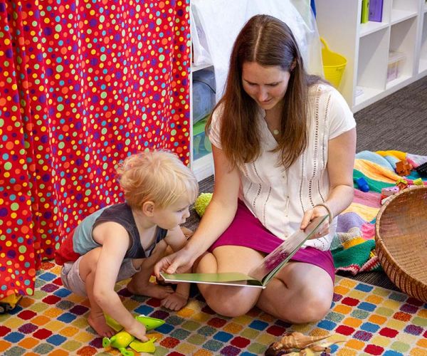 A mum reading a story to her son
