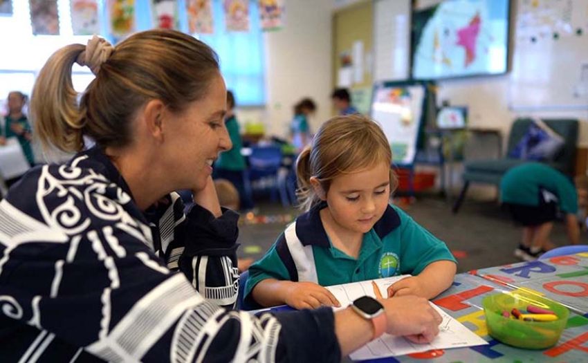 Teacher helping a prep student work through a problem