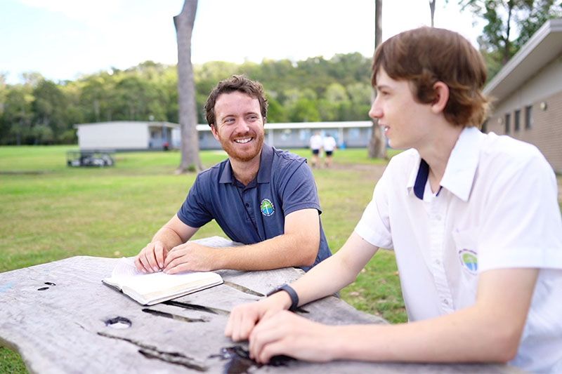 Wellbeing staff meeting with a student outside